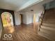 Open living area with hardwood floors and staircase at 252 Ringwood Way, Anderson, IN 46013