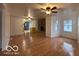 Living room with hardwood floors, stone fireplace and ceiling fan at 252 Ringwood Way, Anderson, IN 46013