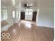 Bright living room with hardwood floors, ample space, updated light fixtures, and neutral paint at 252 Ringwood Way, Anderson, IN 46013