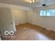 Bright neutral room with wood floors, updated lights, neutral paint, and modern trim work at 252 Ringwood Way, Anderson, IN 46013