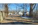 Large backyard with mature trees and a wooden fence at 2925 Stuart St, Indianapolis, IN 46218