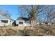 Gray vinyl-sided house with a small front yard and wooden fence at 2925 Stuart St, Indianapolis, IN 46218