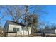Small gray house with a fenced yard and mature trees at 2925 Stuart St, Indianapolis, IN 46218