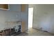 Damaged kitchen with exposed plumbing and cabinets at 2925 Stuart St, Indianapolis, IN 46218