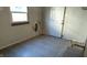 Kitchen with damaged walls, flooring, and exposed plumbing at 2925 Stuart St, Indianapolis, IN 46218