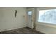 Living room with damaged walls, flooring, and a hole in the wall at 2925 Stuart St, Indianapolis, IN 46218