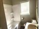 Compact bathroom with a tub-shower combination, neutral walls, and essential fixtures, providing functionality at 3513 N Layman Ave, Indianapolis, IN 46218