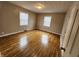 Inviting bedroom with gleaming hardwood floors, two windows for natural light, and neutral walls, creating a serene ambiance at 3513 N Layman Ave, Indianapolis, IN 46218