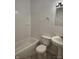 Bathroom featuring a toilet, bathtub with shower, and pedestal sink at 3619 N Hawthorne Ln, Indianapolis, IN 46218