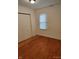 Cozy bedroom featuring wood-look flooring and a double-door closet at 3619 N Hawthorne Ln, Indianapolis, IN 46218