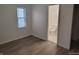 Bright bedroom features wood-look flooring and an en suite bathroom at 3619 N Hawthorne Ln, Indianapolis, IN 46218