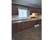 Well-lit kitchen with wood cabinets, laminate countertops, and modern appliances, creating a functional cooking space at 3619 N Hawthorne Ln, Indianapolis, IN 46218