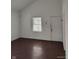 Spacious room with natural light, hardwood flooring, and freshly painted white walls offering a blank canvas for personalization at 3619 N Hawthorne Ln, Indianapolis, IN 46218