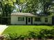 Cozy single-story house with a carport and a green lawn, nestled in a tranquil neighborhood at 3639 Richelieu Rd, Indianapolis, IN 46226