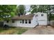 White house with attached garage and small yard at 4013 Patricia St, Indianapolis, IN 46222