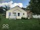 Ranch home with a yellow exterior, green lawn, and stone addition at 4025 N Kitley Ave, Indianapolis, IN 46226