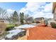 Multi-level deck with fire pit, partially covered in snow at 4549 Pepper Ct, Indianapolis, IN 46237