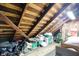Unfinished attic space, showcasing exposed wooden beams and rafters, provides ample storage potential at 4616 Carrollton Ave, Indianapolis, IN 46205