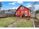 Spacious backyard with a wooden deck, bench, grill, and well-maintained lawn, perfect for outdoor enjoyment at 4616 Carrollton Ave, Indianapolis, IN 46205