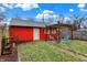 Charming backyard featuring a cozy pergola seating area and a detached painted garage at 4616 Carrollton Ave, Indianapolis, IN 46205