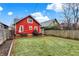 Well-maintained backyard featuring a wooden deck, bench, and vibrant green lawn, perfect for relaxation at 4616 Carrollton Ave, Indianapolis, IN 46205