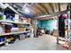 Unfinished basement with open ceiling, features painted walls, storage shelves, and exercise equipment at 4616 Carrollton Ave, Indianapolis, IN 46205