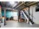 Unfinished basement with open ceiling and stairs, features painted walls, and laundry hookups at 4616 Carrollton Ave, Indianapolis, IN 46205