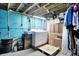 Finished basement with laundry area, painted walls, open ceiling, and ample storage space at 4616 Carrollton Ave, Indianapolis, IN 46205