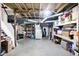 Unfinished basement with open ceiling, features painted walls, storage, and mechanical equipment at 4616 Carrollton Ave, Indianapolis, IN 46205