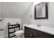 Clean bathroom features a modern vanity with sleek fixtures and tiled floor, next to an elongated toilet at 4616 Carrollton Ave, Indianapolis, IN 46205