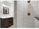 Modern bathroom boasts neutral tiling, a sleek vanity, and a walk-in shower with a rainfall showerhead at 4616 Carrollton Ave, Indianapolis, IN 46205