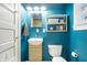 Bright bathroom features modern vanity, toilet, and convenient shelving unit at 4616 Carrollton Ave, Indianapolis, IN 46205