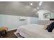 Bedroom with sloped ceilings, hardwood floors, a mini-split AC, and large window at 4616 Carrollton Ave, Indianapolis, IN 46205