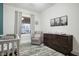 Bright Bedroom with a comfortable chair, changing table, and a soft rug at 4616 Carrollton Ave, Indianapolis, IN 46205