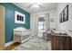 Beautiful Bedroom with a teal accent wall, window, and a white crib at 4616 Carrollton Ave, Indianapolis, IN 46205