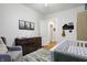 Inviting Bedroom with forest-themed decor, dresser and a white crib at 4616 Carrollton Ave, Indianapolis, IN 46205