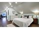 Cozy bedroom with sloped ceilings, hardwood floors, and ensuite office at 4616 Carrollton Ave, Indianapolis, IN 46205