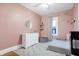 Charming bedroom with a play kitchen, large window and neutral-colored carpet at 4616 Carrollton Ave, Indianapolis, IN 46205