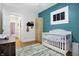 Well-lit Bedroom with a crib, and view to the entryway at 4616 Carrollton Ave, Indianapolis, IN 46205