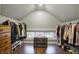 Walk-in closet with hardwood floors, window, chest, and clothing racks at 4616 Carrollton Ave, Indianapolis, IN 46205
