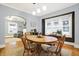 Inviting dining room with hardwood floors, an oval table, and large windows with natural light at 4616 Carrollton Ave, Indianapolis, IN 46205