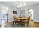 Bright dining room with hardwood floors, a wooden bench and an arched entry to the kitchen at 4616 Carrollton Ave, Indianapolis, IN 46205