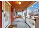 Welcoming porch with wood ceiling, porch swing and a view of the neighborhood at 4616 Carrollton Ave, Indianapolis, IN 46205