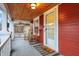 Inviting porch with rocking chairs, wood ceiling, a 'hello' rug and a front door entrance at 4616 Carrollton Ave, Indianapolis, IN 46205