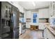 Spacious kitchen with stainless steel appliances, white cabinets, granite countertops and hardwood floors at 4616 Carrollton Ave, Indianapolis, IN 46205