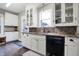 Bright kitchen with white cabinets, granite countertops, stainless steel appliances and hardwood floors at 4616 Carrollton Ave, Indianapolis, IN 46205
