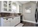 Well-lit kitchen features white cabinetry, granite countertops, stainless steel appliances and hardwood floors at 4616 Carrollton Ave, Indianapolis, IN 46205