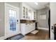 Charming kitchen with white cabinetry, stainless steel appliances, and an exterior door at 4616 Carrollton Ave, Indianapolis, IN 46205