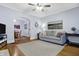 Cozy living room featuring wood floors, a neutral sofa, and an open archway to dining at 4616 Carrollton Ave, Indianapolis, IN 46205