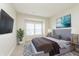 Modern bedroom with a plush bed, stylish rug, bedside tables, and natural light from the window at 5437 Basin Park Dr, Indianapolis, IN 46239